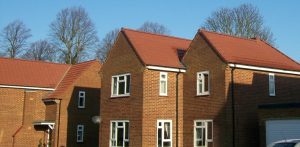 view of several Ministry of Defence residential houses reroofed in smart red tiles by Kingsley Roofing